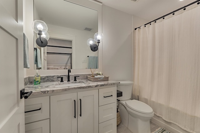 full bathroom with tile patterned flooring, vanity, shower / tub combo, and toilet