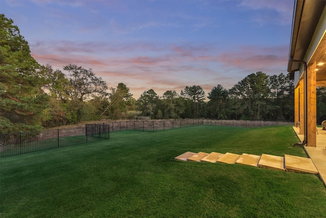 view of yard at dusk