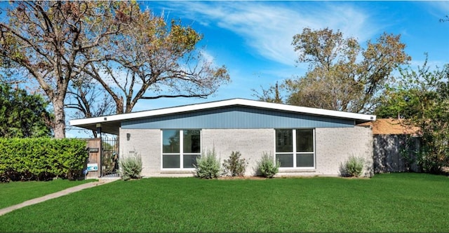 rear view of property featuring a yard