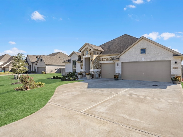 view of front of property with a garage and a front lawn