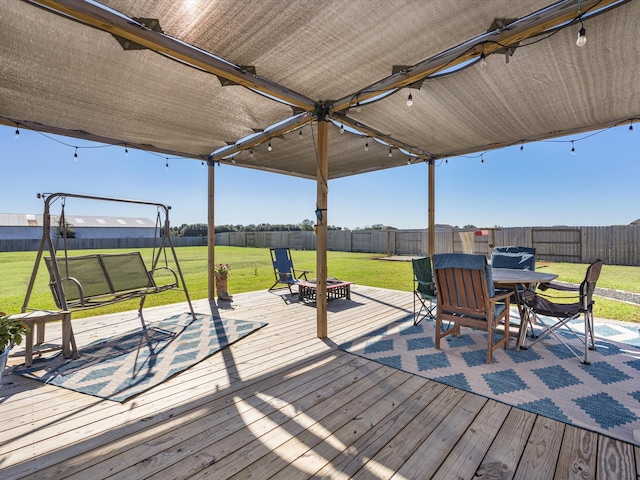 deck with a yard and a fire pit