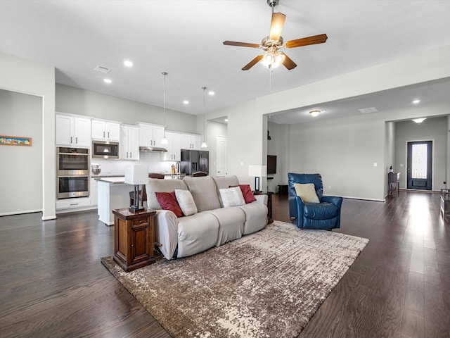 living room featuring ceiling fan and dark hardwood / wood-style flooring