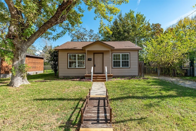 bungalow-style home featuring a front yard