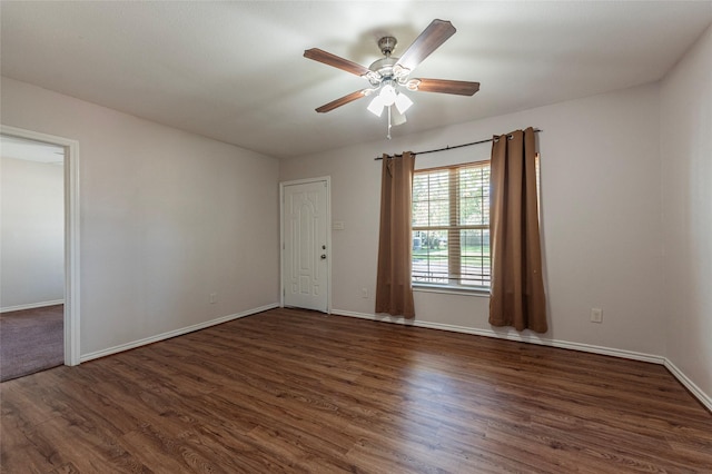 empty room featuring ceiling fan and dark wood-type flooring