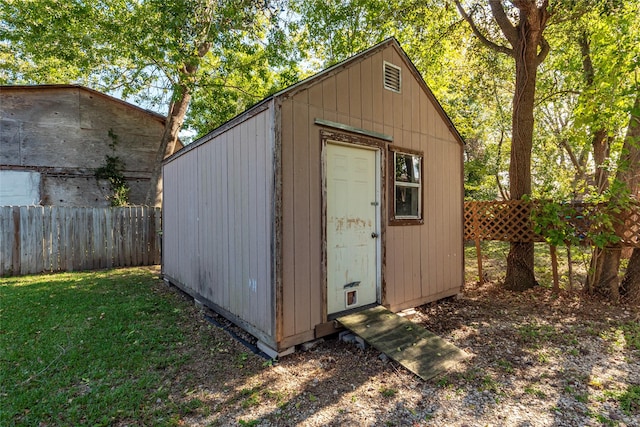 view of outbuilding with a lawn