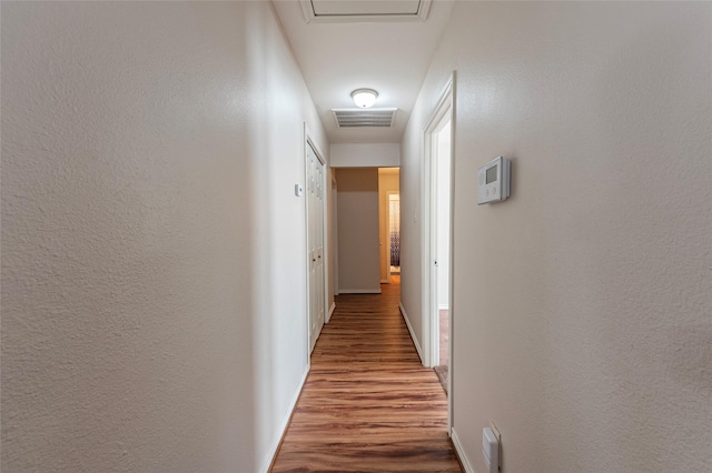 hallway with hardwood / wood-style floors