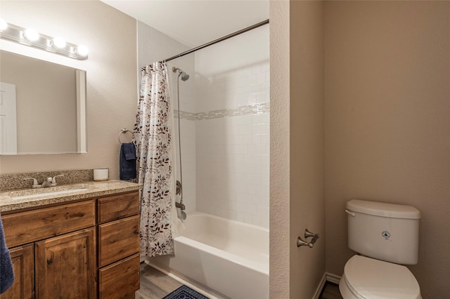 full bathroom featuring shower / bath combo with shower curtain, vanity, hardwood / wood-style floors, and toilet