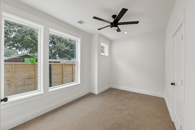 spare room featuring ceiling fan and carpet