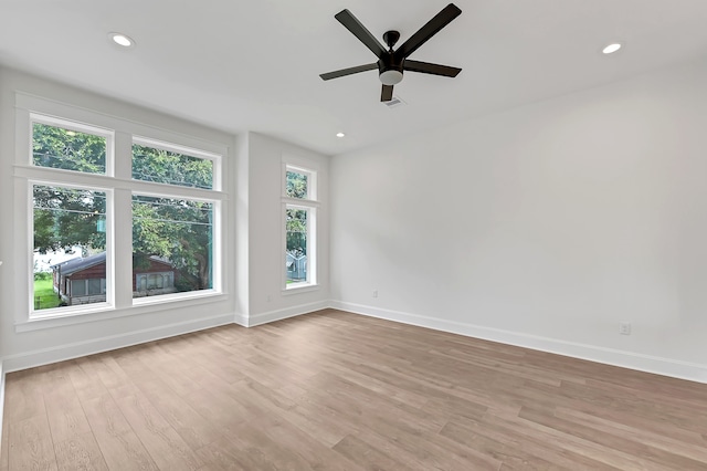 spare room featuring ceiling fan and light hardwood / wood-style floors