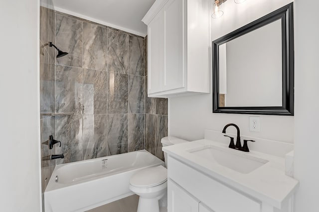 full bathroom featuring tiled shower / bath combo, toilet, and vanity