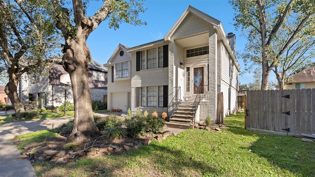 view of front of property featuring a front lawn and a garage