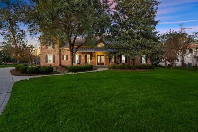 view of front of house featuring french doors and a front yard