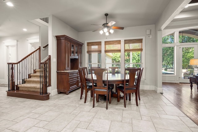 dining room with baseboards, ceiling fan, stairs, stone tile flooring, and recessed lighting