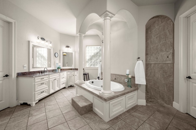 full bathroom with a garden tub, tile patterned flooring, vanity, and decorative columns