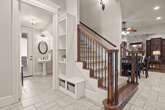 stairs featuring a ceiling fan, recessed lighting, baseboards, and stone tile floors