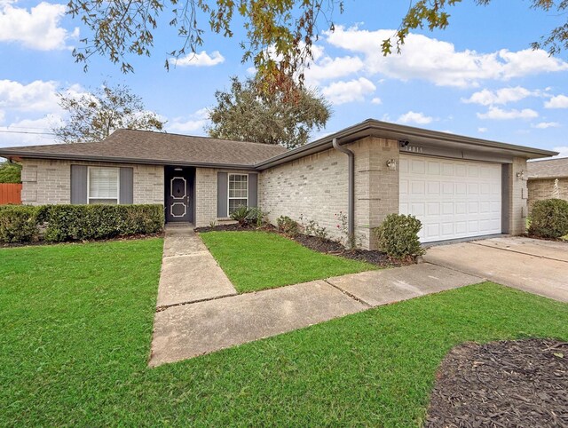 ranch-style home with a garage and a front lawn