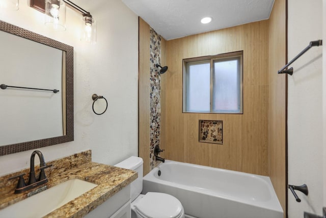 full bathroom with vanity, a textured ceiling, tub / shower combination, and toilet