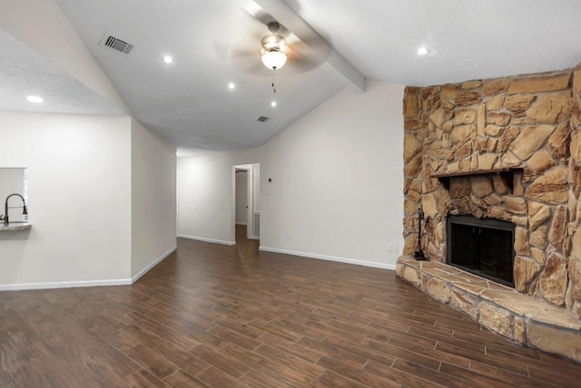 unfurnished living room featuring lofted ceiling with beams, ceiling fan, dark wood-type flooring, and a fireplace