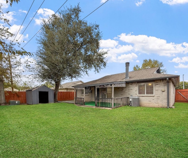 back of house with a patio, a yard, central AC unit, and a storage shed