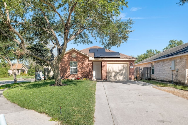 view of front facade featuring solar panels, a garage, and a front lawn