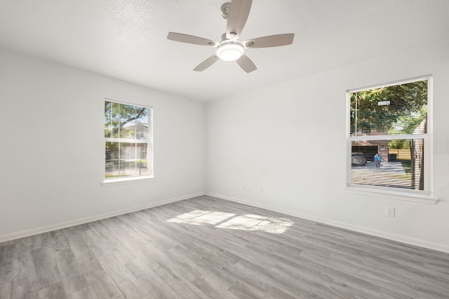 spare room with light hardwood / wood-style floors and ceiling fan