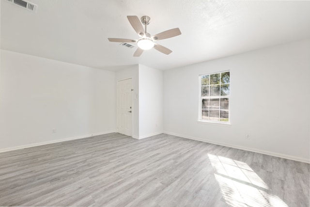 spare room featuring light hardwood / wood-style floors and ceiling fan