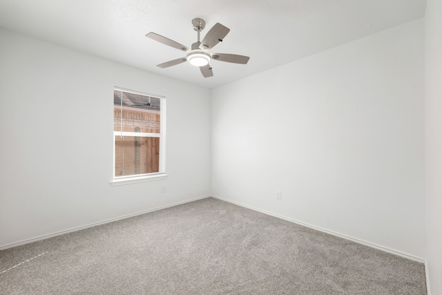 empty room with ceiling fan and carpet floors