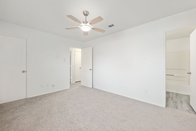 empty room featuring light colored carpet and ceiling fan