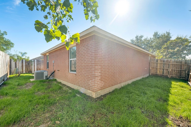 view of property exterior featuring a lawn and central AC