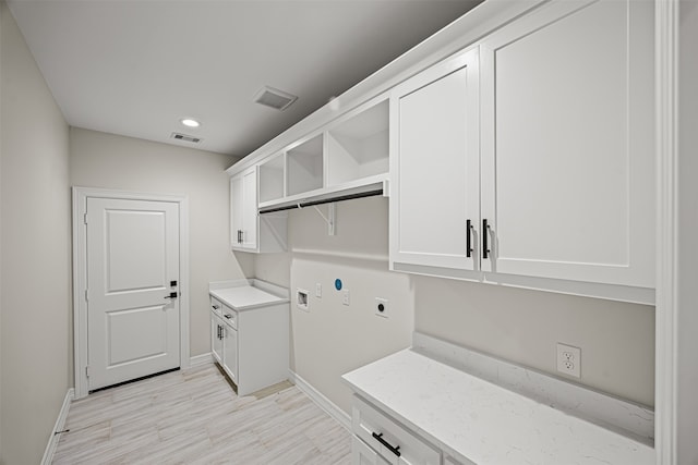 laundry room with hookup for an electric dryer, cabinets, and washer hookup