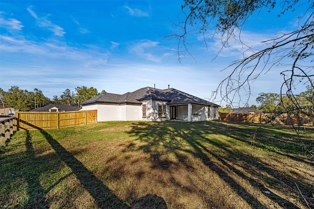 rear view of house with a lawn