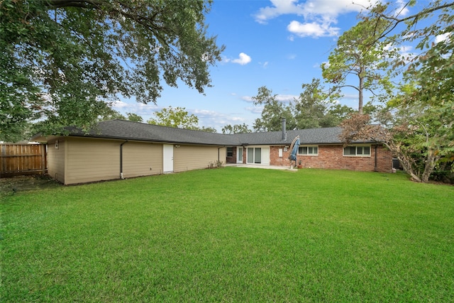 back of house with a yard