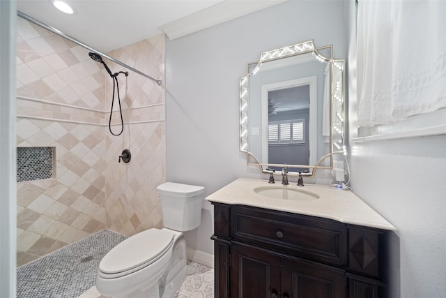 bathroom featuring tile patterned floors, vanity, toilet, and tiled shower