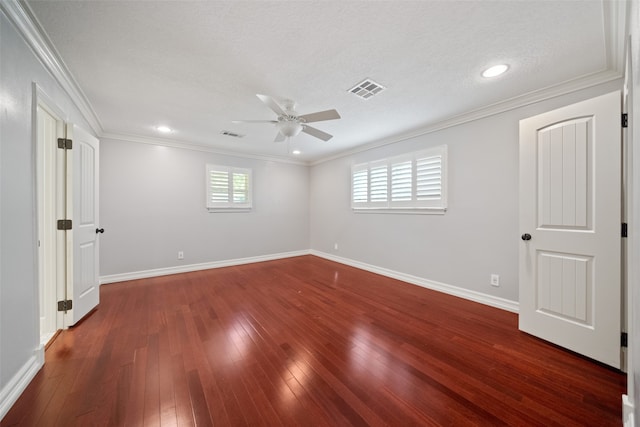 spare room with a textured ceiling, crown molding, ceiling fan, and dark wood-type flooring