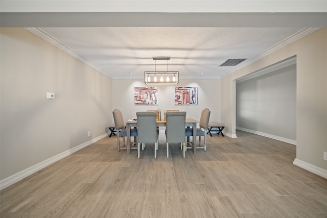 dining space featuring light hardwood / wood-style flooring and ornamental molding