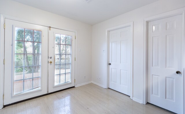 doorway featuring french doors and light hardwood / wood-style flooring