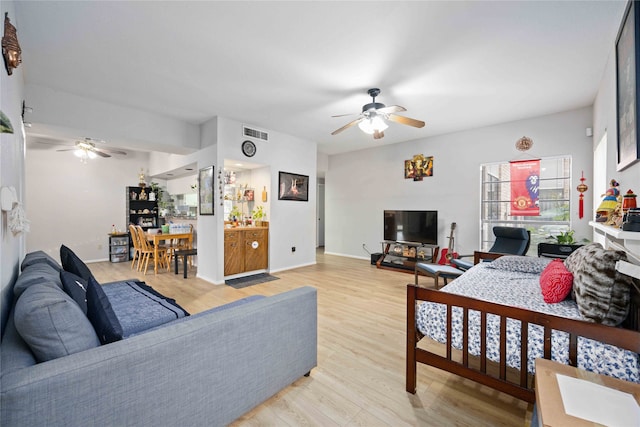 living room featuring ceiling fan and light hardwood / wood-style floors