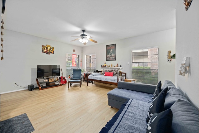 living room featuring ceiling fan and light hardwood / wood-style flooring