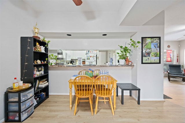 dining room with light hardwood / wood-style floors and ceiling fan