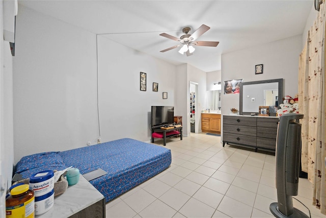 tiled bedroom featuring ensuite bath and ceiling fan