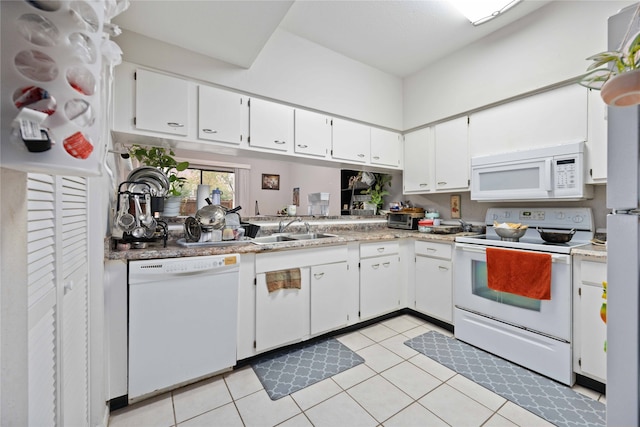 kitchen featuring white cabinetry, sink, light tile patterned floors, and white appliances