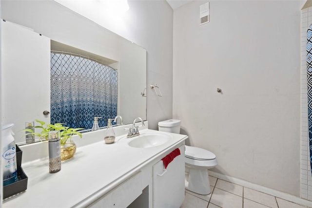 bathroom featuring toilet, vanity, and tile patterned floors