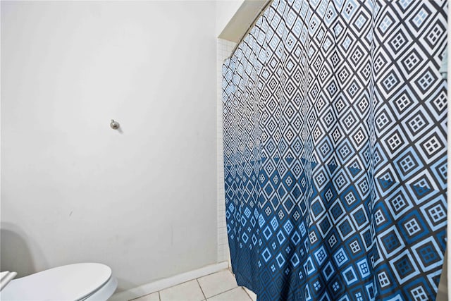 bathroom featuring tile patterned flooring and toilet