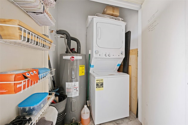 clothes washing area featuring stacked washer / dryer and electric water heater