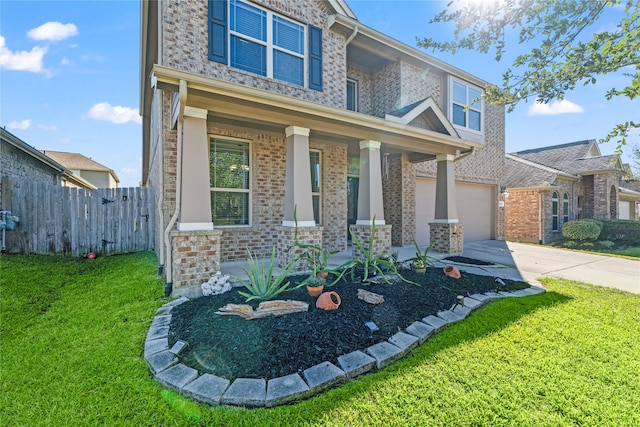 view of front of house with a porch, a garage, and a front yard