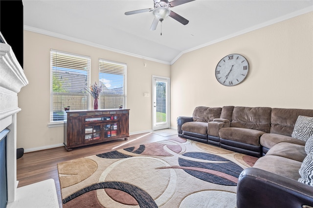 living room with hardwood / wood-style floors, crown molding, ceiling fan, and lofted ceiling