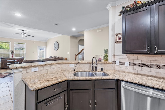 kitchen featuring kitchen peninsula, light stone counters, crown molding, sink, and dishwasher