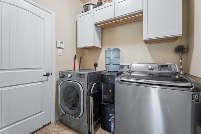 laundry area featuring washing machine and dryer and cabinets