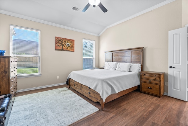 bedroom featuring vaulted ceiling, ceiling fan, dark wood-type flooring, and crown molding