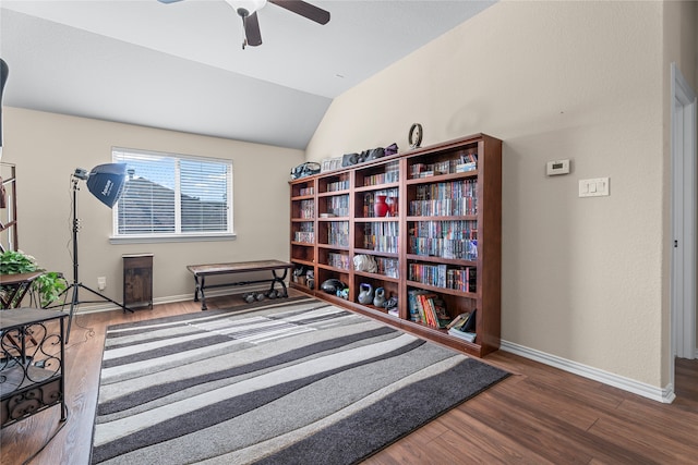 living area featuring ceiling fan, dark hardwood / wood-style floors, and lofted ceiling